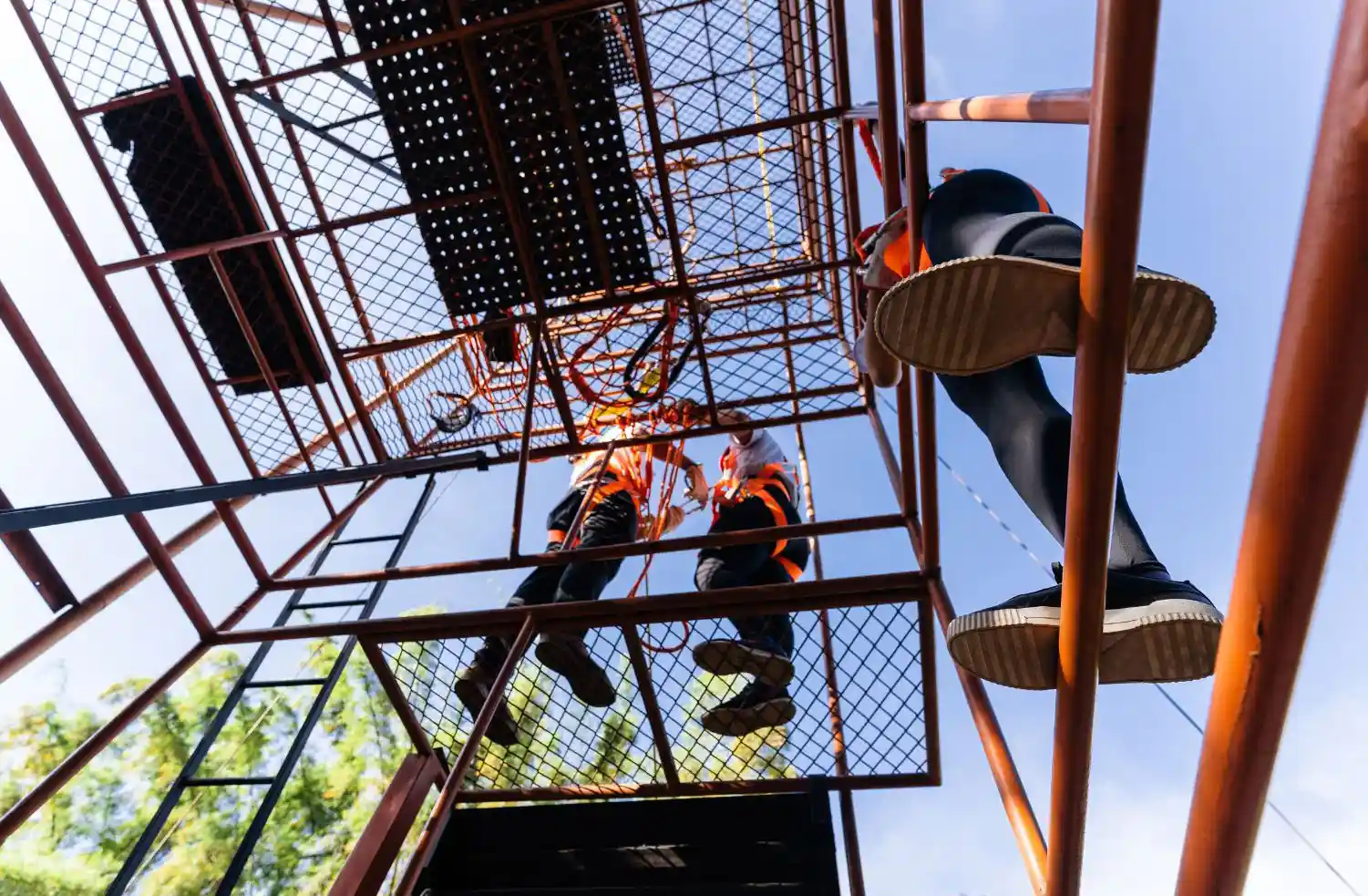 Huntington Beach Scaffolding crew assembling elevated scaffold structure with safety harnesses and protective equipment